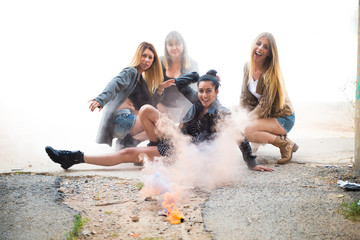 Group of young friends with smoke bomb