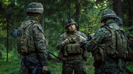 Squad Leader Discusses Military Operation Details with Soldiers, Commander Gives Orders. Fully Equipped and Armed Soldiers Ready for Mission in a Dense Forest.