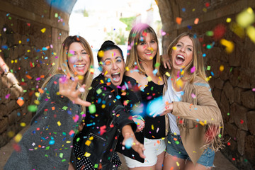 Group of young friends with confetti