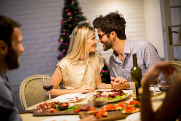 Young people celebrating New Year and drinking red wine