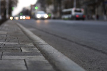 By city road going car at sunset