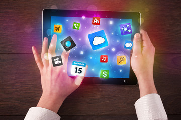 hands holding tablet