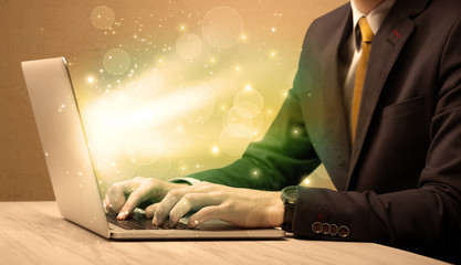 Businessman working fast on laptop