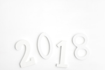 White wooden numbers 2018 on white. New year concept. Text space