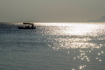 Naklejka premium boat on the sea in the distance 