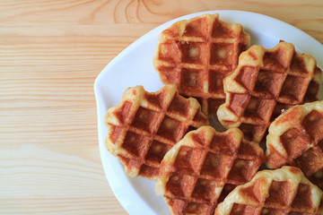 Top View of a Plate of Belgian Waffles on Served on Wooden Table, with Free Space for Text or Design 