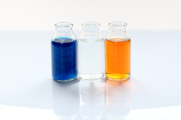 chemical vessels with colorfull liquids on white background