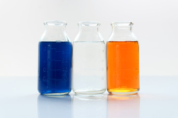 chemical vessels with colorfull liquids on white background