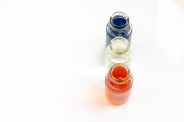 chemical vessels with colorfull liquids on white background