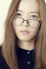Portrait of a Asian young woman with glasses on white background