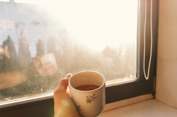 having a cup of tea in winter at home, warming up in cold