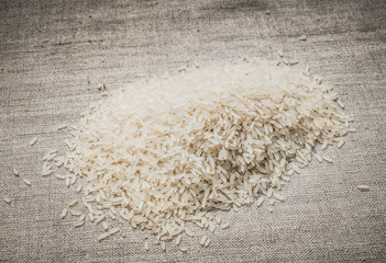 Rice groats on a linen tablecloth background. Carbohydrate diet