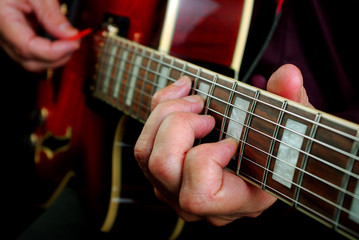 playing electric guitar. play the guitar. closeup.