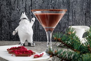 chocolate shake in a glass on a high stem, decorated with cocoa and chocolate with raspberries