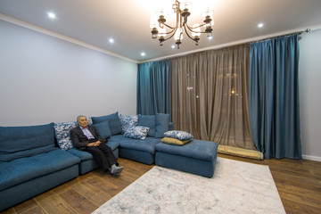 living room with large chandelier,pensioner sits on the couch
