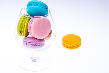Delicate delightful delicious colored macaroons on white background