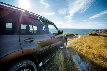 SUV car moving down to the sea © S_E