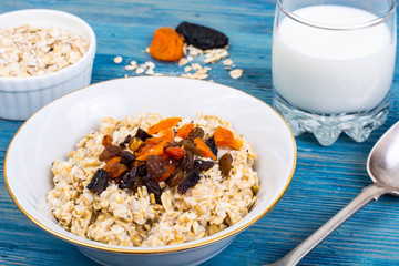 Porridge of oatmeal with dried fruits and chia seeds