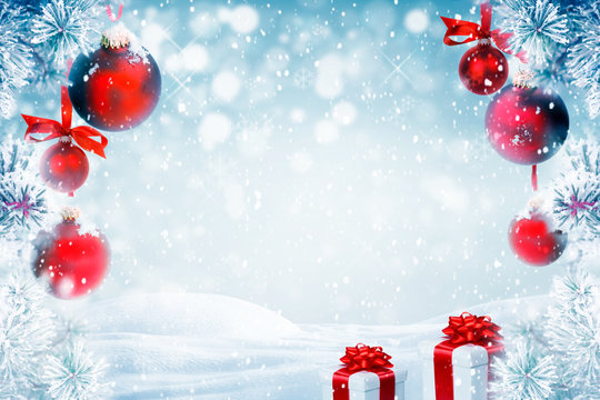Christmas background with red ornaments, gift boxes and falling snow 