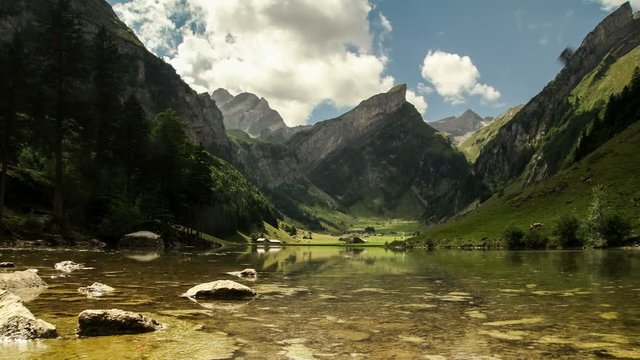 Time lapse clouds move over mountain lake Seealpsee in Alpstein Appenzell region switzerland travel swiss Alps