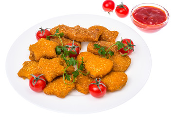 Nuggets of different shapes with ketchup on white background