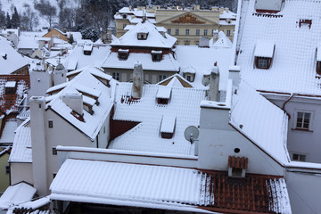 The Look on the snowy Roofs of the old gothic Town Prague
