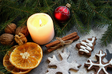 Fototapeta na wymiar Christmas cakes near a lit candle, spices. Food. Background.