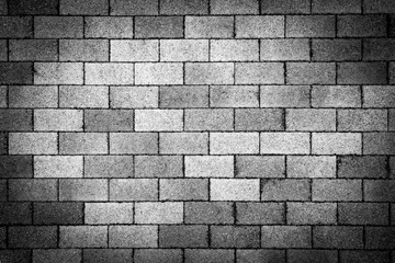 Black and white brickwork with spotlight (background, abstract, vignetting)