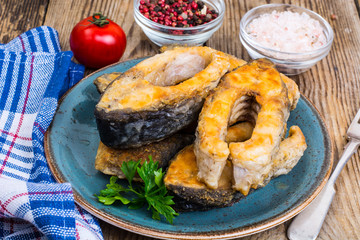 Pieces of fried fish on blue plate