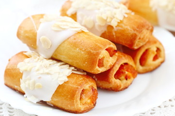 Roll with sweet cream, almonds and apricot jam