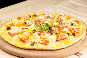Pizza with seafood on wooden table
