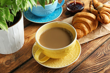 Ceramic cup with delicious coffee on wooden table