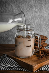 Preparing delicious iced coffee on table