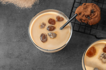 Glass with delicious iced coffee on table