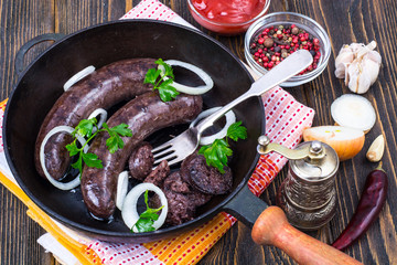 Hot blood sausage with onion on pan