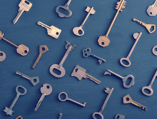 rusty old keys locks - on dark wooden rustic background