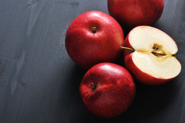 Fototapeta na wymiar red ripe apples on a dark rustic wooden background