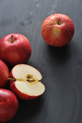 Naklejka na ściany i meble red ripe apples on a dark rustic wooden background