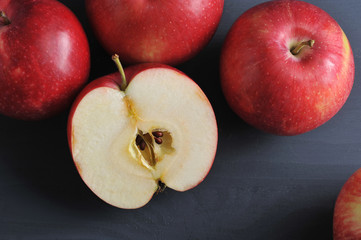 red ripe apples on a dark rustic wooden background