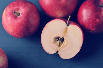 red ripe apples on a dark rustic wooden background