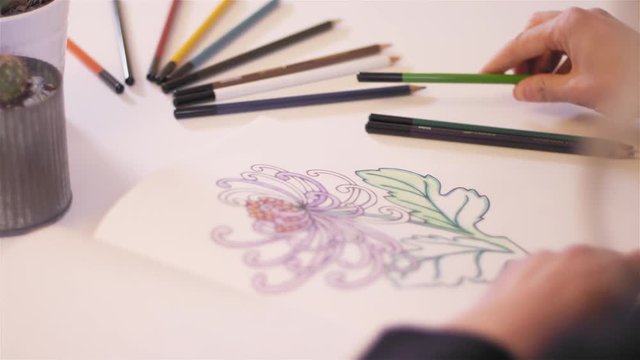 Close up shot of someone using an adult coloring book