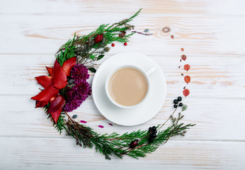 A cappuccino cup in a white dish with a new decor on the table