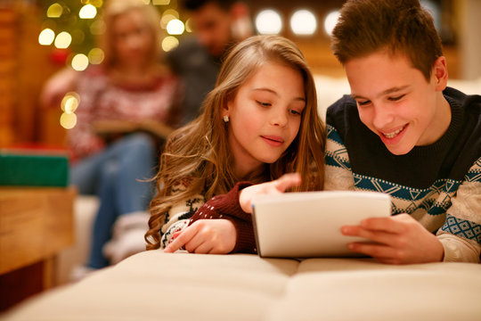 happy boy and girl lying and writes letter to Santa Claus for Christmas .