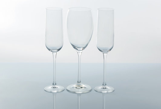 three empty wine glass on a light background.