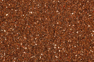 Brown glitter background with glow.