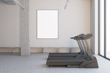 Two treadmills in a white room, close up side
