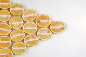 sliced lemons half on a light background