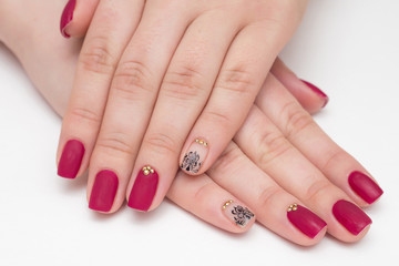 Closeup of hands of a young woman with red manicure on nails