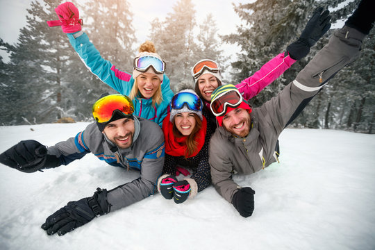 Skiers lying on snow and having fun