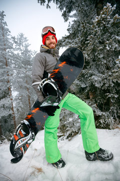 smiling young man snowboarder